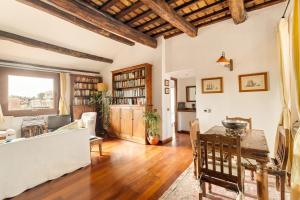 a living room with a table and a couch at Piazza Mattei Terrace Apartment | Romeloft in Rome