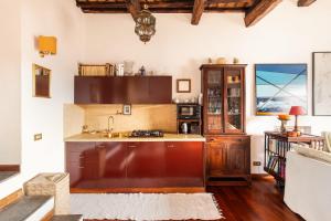a kitchen with a sink and a counter top at Piazza Mattei Terrace Apartment | Romeloft in Rome