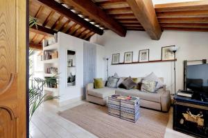 a living room with a couch and a tv at Pantheon Stylish Attic in Rome