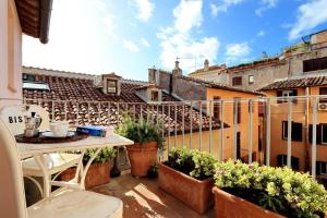 a balcony with a table and some plants at Pantheon Stylish Attic in Rome