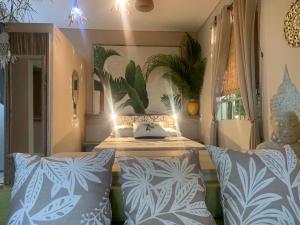 a bedroom with a bed with blue and white pillows at The Palms Ocean views in Rodrigues Island