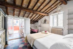 a bedroom with a large bed and a bath tub at Scala Lovely Terrace Apartment in Rome