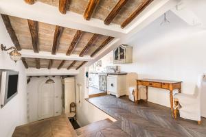 a living room with white walls and wooden ceilings at Scala Lovely Terrace Apartment in Rome