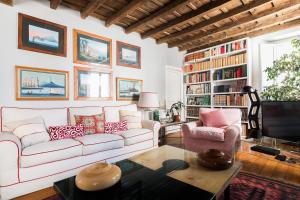 a living room with a white couch and a tv at Farnese Charming Apartment in Rome