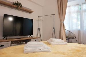 - une chambre avec une télévision et 2 serviettes blanches sur un lit dans l'établissement Konstanzer Tudor3, à Iaşi