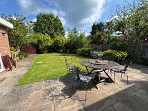 a patio with a table and chairs in a yard at Private Apartment in Windsor in Windsor