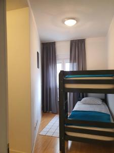 a small room with a bunk bed and a hallway at Dream in Sibenik in Šibenik
