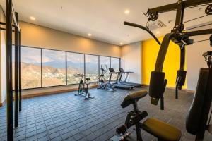 a gym with several tread machines and a large window at Exclusive Luxury Apartment 2 BRD In Rodadero in Gaira