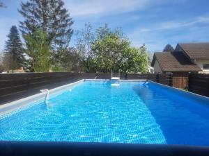 a large swimming pool with blue water at GITE CHEZ MONETTE in Nance