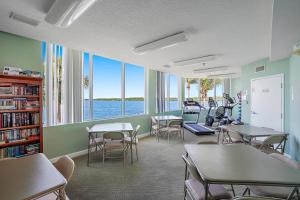 a classroom with tables and chairs and a large window at Oceanfront Luxury Condo! Mins to beach! Rum Bar Next Door! in St Petersburg