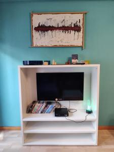 a white entertainment center with a flat screen tv at Euforbia House in Lido di Ostia