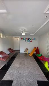 a play room with chairs and a slide at Espaço para sentir-se bem. in Fortaleza