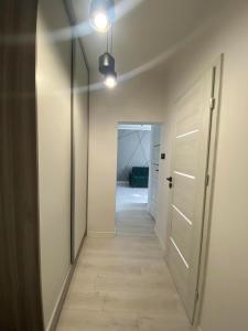 an empty hallway with a door and a hallwayngthngthngthngthngthngthngth at J.D Apartment in Gniezno