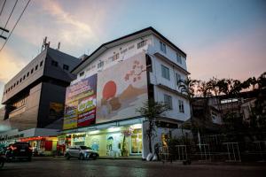 a building with a large mural on the side of it at Miki House in Chumphon