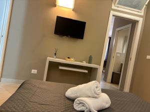 En eller flere senge i et værelse på Sikanart Home