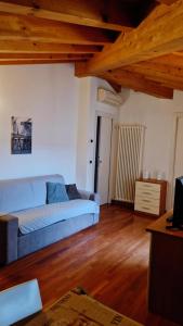 sala de estar con sofá azul y suelo de madera en Apartments Tony in Bardolino, en Bardolino