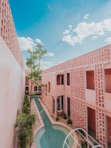 a view of the courtyard of a building with a swimming pool at Casa Amate 61 Boutique Hostel in Mérida