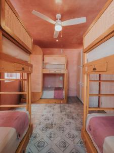 a room with two bunk beds and a ceiling at Casa Amate 61 Boutique Hostel in Mérida