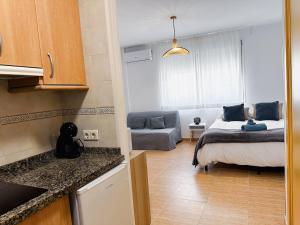 a kitchen and a bedroom with a bed and a couch at Sea Estudio Cala de Mijas in La Cala de Mijas