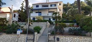 a house with stairs in front of a building at Apartments & Rooms Bianca in Mali Lošinj