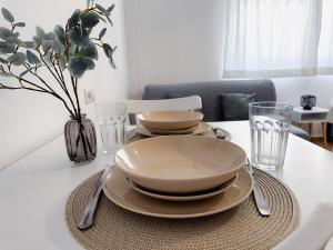 a table with plates and bowls on top of it at Sea Estudio Cala de Mijas in La Cala de Mijas +8 photos