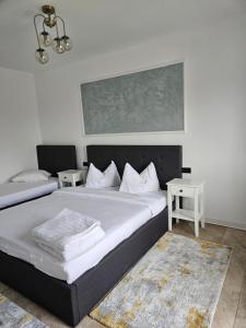 a bedroom with a large bed with white sheets at Casa Mariana in Murighiol