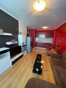 a living room with a couch and a kitchen at Apart hotel Gallery L in Sunny Beach
