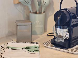 a kitchen counter with a blender and a cup at Mparmpa Nikoli in Skiros