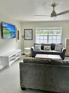 a living room with a couch and a table at Perfect remote work spot! Close to everything! in West Palm Beach