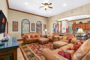 a living room with leather furniture and a ceiling fan at Lighthouse Hill Ranch - Lighthouse in Johnson City