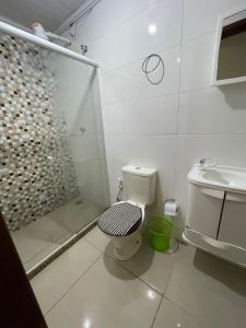 a bathroom with a shower and a toilet and a sink at Dom Antonio 3 in Campos dos Goytacazes