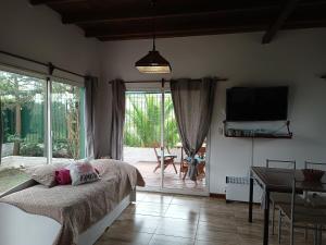 a bedroom with a bed and a sliding glass door at Casa 2 pisos Para 5 personas toda equipada in Colonia del Sacramento