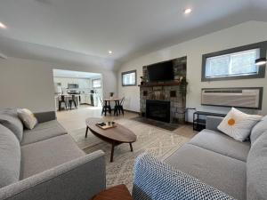 a living room with a couch and a fireplace at East Rock Inn in Great Barrington