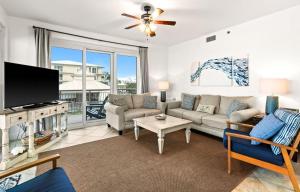 a living room with a couch and a tv at High Pointe Resort E26 in Inlet Beach