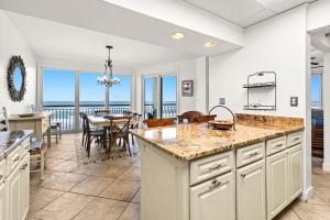 a kitchen and dining room with a view of the ocean at High Pointe Resort E26 in Inlet Beach