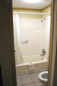 a bathroom with a bath tub and a toilet at Executive Inn & Suites in Nashville