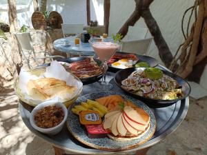 a table with plates of food and a drink at Holbox by Xaloc in Holbox Island