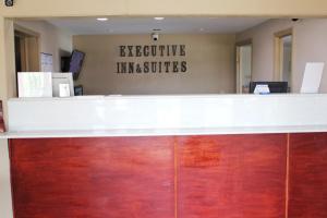 an office counter with a sign that reads at Executive Inn & Suites in Nashville