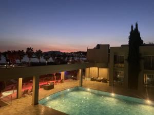 a house with a swimming pool at night at Hotel Ambrosia in Bitez