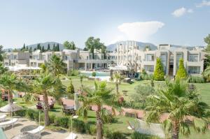 an aerial view of a resort with palm trees at Ambrosia Hotel Beach & Spa in Bitez