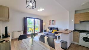 a kitchen and living room with a table and a couch at El Rincon de las Americas in Colombres