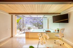 a kitchen and living room with a tub and a table at El Santuario Resort & Spa in Valle de Bravo