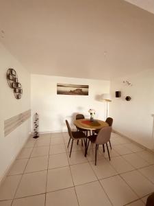 ein Esszimmer mit einem Tisch und Stühlen in der Unterkunft Villa KLYTANLY in Le Robert