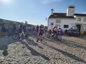 a group of people riding bikes on a dirt road at El-Rei Dom Manuel Hotel in Marvão