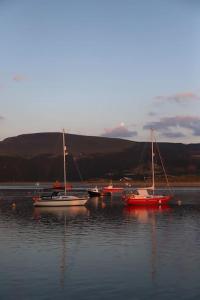 a group of boats sitting in the water at Hen Blas, 14th century 2 bedroom Cottage in Barmouth
