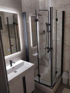 a bathroom with a shower and a sink at Motel & Restoran "VIDIKOVAC" in Mostar