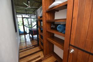 a room with wooden shelves and a door at Selva Madre Eco-Sanctuary in Cahuita