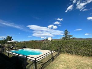 a swimming pool with a fence around it at Entre Sierras VGB Bertone in Villa General Belgrano