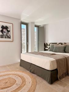 a bedroom with a large bed and a large window at Egeo Paros in Kampos Paros