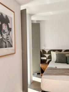 a bedroom with a bed and a picture on the wall at Egeo Paros in Kampos Paros